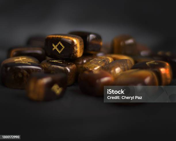 Dark And Moody Nordic Viking Tiger Eye Gemstone Runes Collection Stock Photo - Download Image Now