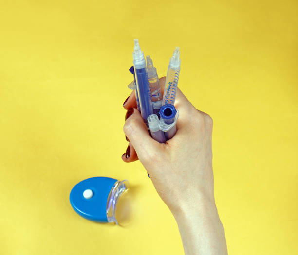 istock Female hand holding plastic syringes 1300173290