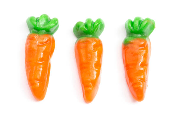 istock Gummy Candy Carrots Isolated on a White Background 1300173477