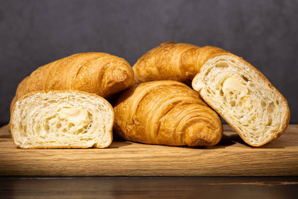 istock fresh croissants on wooden board on a dark background 1300174991