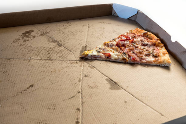 istock Last slice of pizza in a delivery cardboard box 1300176190