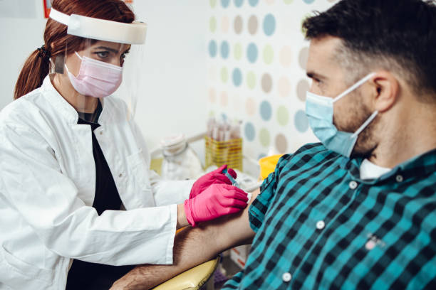 istock Mature man taking a vaccine from his doctor 1300176487