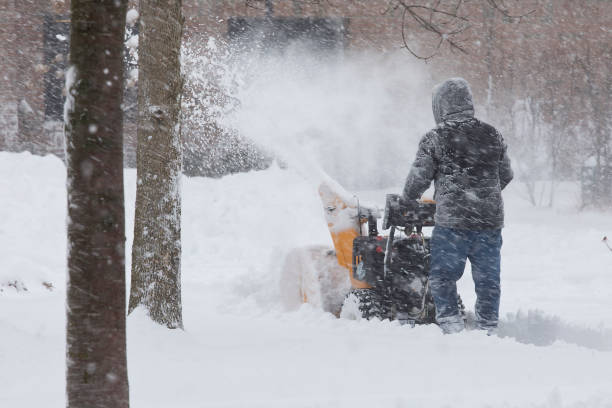 istock Man using snow blower in heavy snow storm 1300177299