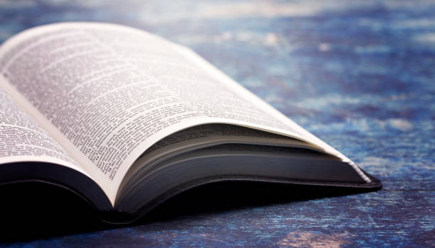istock Bible Open on a Rustic Blue Wooden Table 1300177969