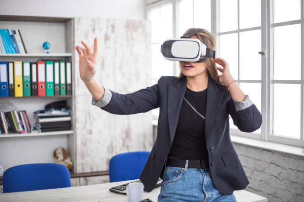 istock Woman Working In Office With VR Headset 1300180754