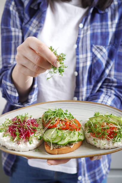 istock Woman doing healthy vegan toasts with microgreens on a breakfast. 1300183063