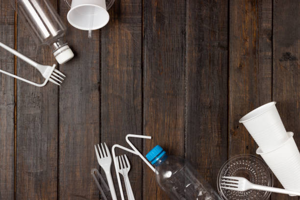 istock Plastic dishes, bottles, glasses on a white table. Planet pollution. 1300183624