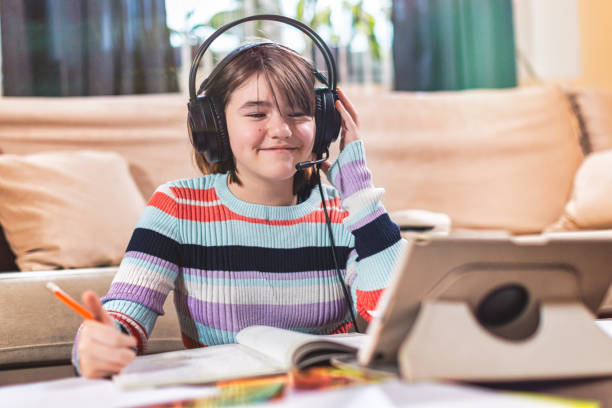 istock Little girl attending to online school class 1300184859