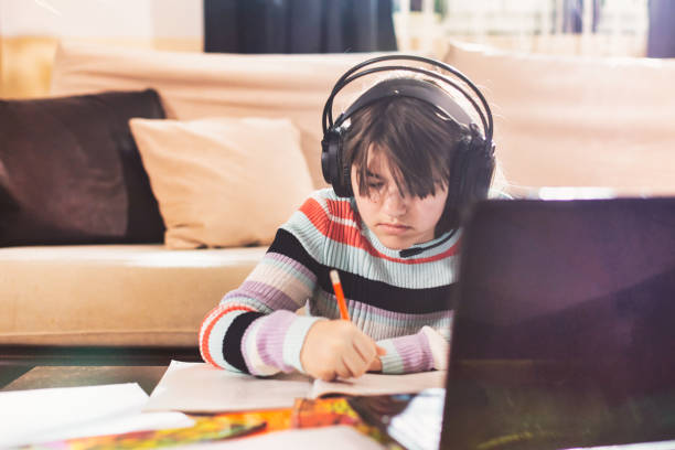 istock Little girl attending to online school class 1300184871