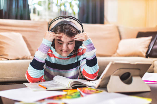 istock Little girl attending to online school class 1300184980