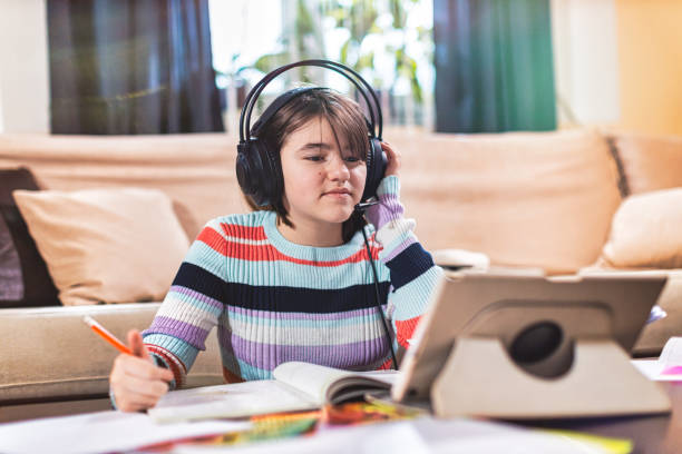 istock Little girl attending to online school class 1300184998