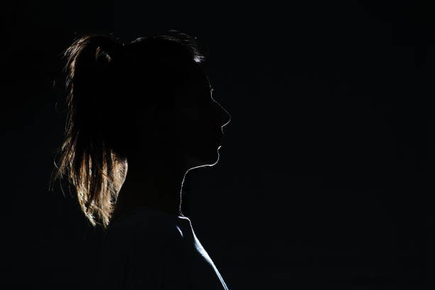 istock Silhouette of attractive women with ponytail looking forward 1300189146