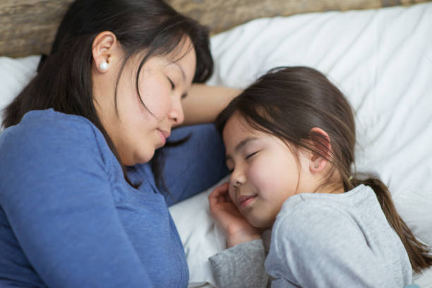 istock Mother and daughter sleeping 1300191783