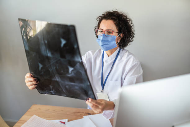 istock Female doctor examing test results during pandemic 1300191803