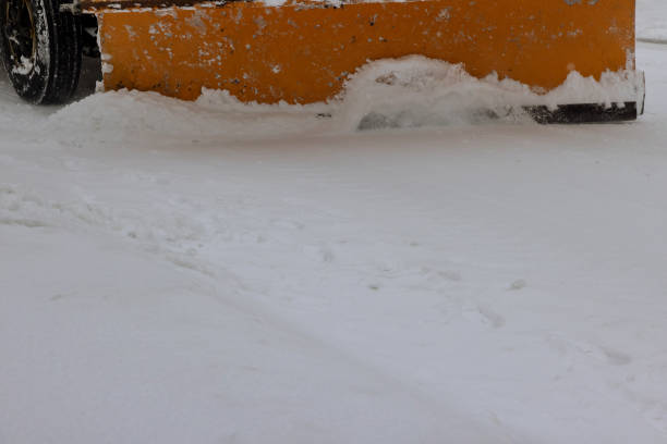 istock Tractor clears the snow removal vehicle removing snow way after heavy snowfall 1300193352
