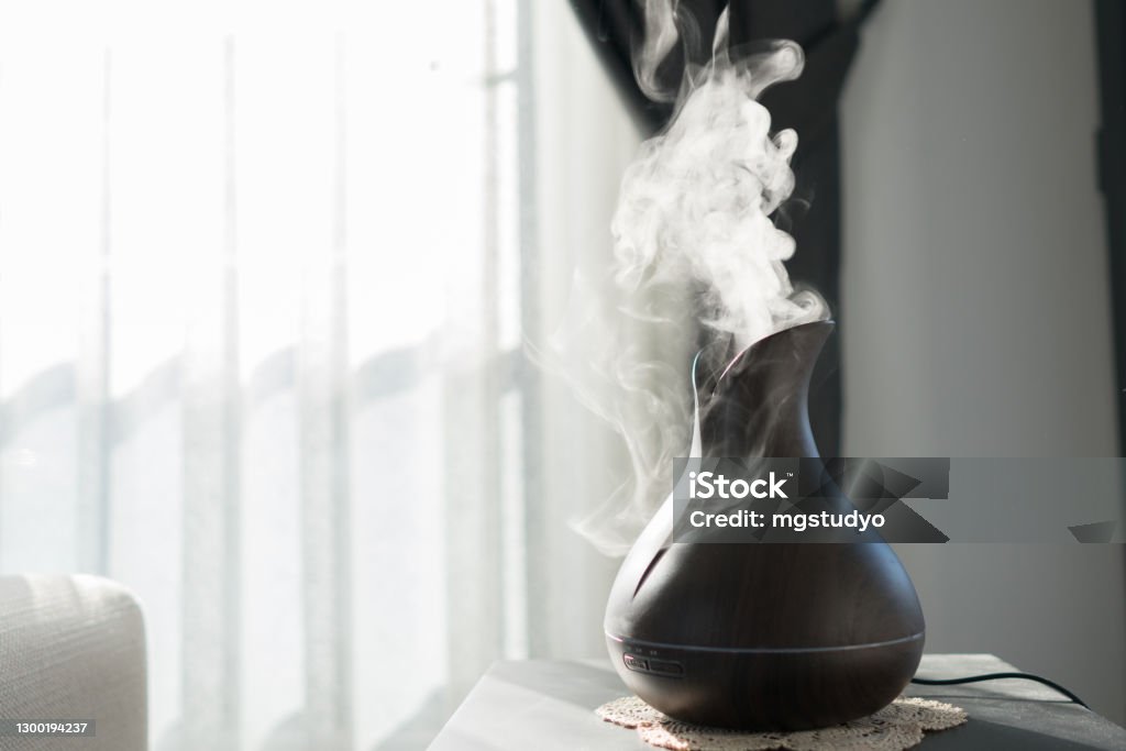 Aroma oil diffuser lamp on the table . Aroma oil diffuser lamp on the table on a blurred background . Aromatherapy Diffuser Stock Photo