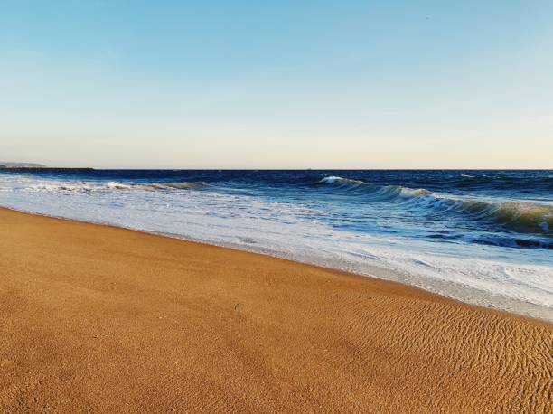 istock Ocean waves washing up onto sandy beach 1300194294