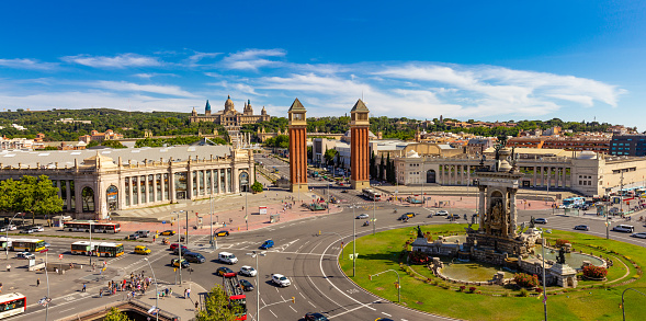 Barcelona, Catalonia Spain - 26 JUlY 2019: Aerial rooftop view of Placa d'Espanya or Plaza de Espana, Spanish Square and Fountain Of Montjuic in summer sunny day. National Museum of Art on background