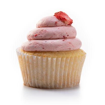 This is a photograph of a gourmet colorful pink strawberry cupcake on a white background