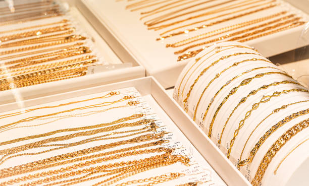 gold chains and bracelets on jewelry display stock photo
