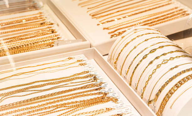 gold chains and bracelets on jewelry display gold chains and bracelets on jewelry display jewelry store stock pictures, royalty-free photos & images