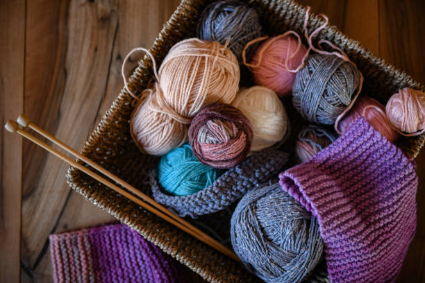 istock Accessories for knitting in basket ( yarn, needles) and scarf 1300200611