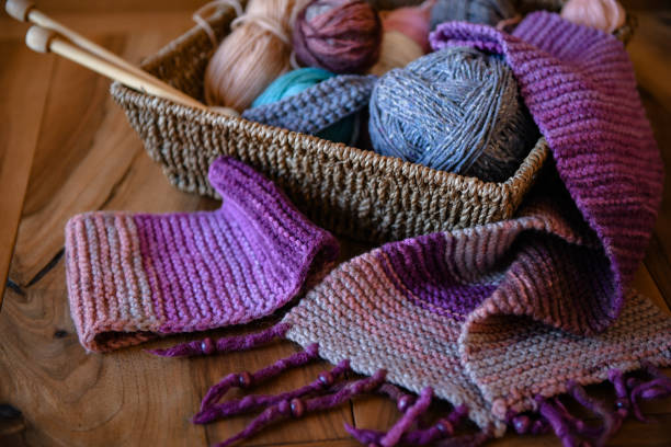 istock Accessories for knitting in basket ( yarn, needles) and scarf 1300201295