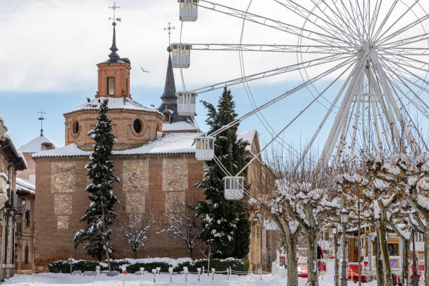 Chapel of the Oidor in the city of Alcala de Henares after a snowy day horizontal view in foreground of the oidor chapel on the city of alcala de henares snowy covered on a cludy day after a snowfall alcala de henares stock pictures, royalty-free photos & images