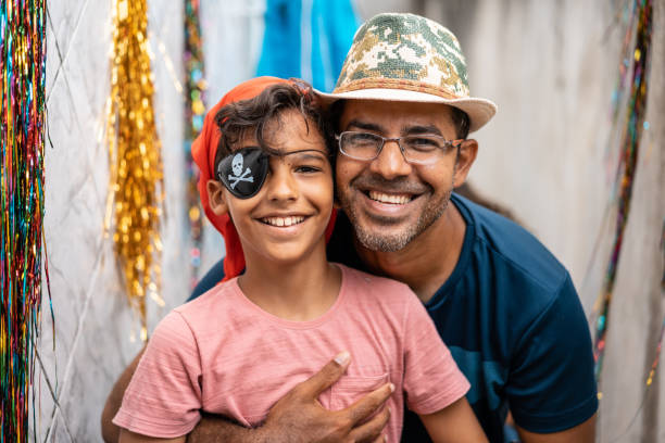 Portrait of father and son at carnival at home Carnival during the pandemic in Brazil festival goer stock pictures, royalty-free photos & images