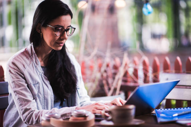 istock Beautiful female student drinking coffee and working in cafeteria. 1300204458