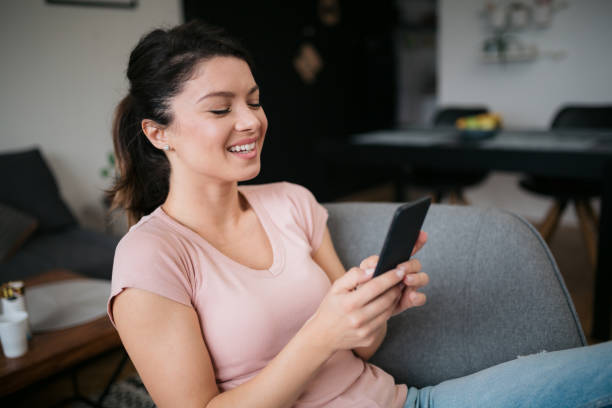 istock Young Caucasian woman planning her day using a smart phone 1300206963