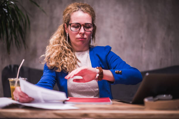 istock Young beautiful female looking at wrist watch. 1300209252