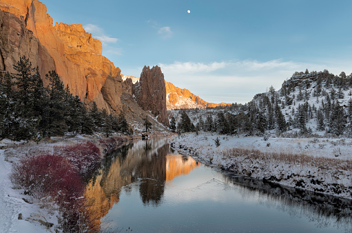 Reflections in the Crooked River of looming cliffs of Smith Rock