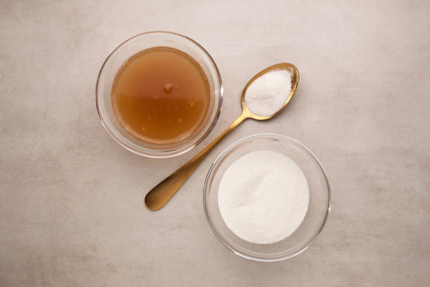 Collagen powder and bone broth with collagen on light stone background. Extra protein intake. Natural beauty and health nutrient supplements for skin, bones. Top view