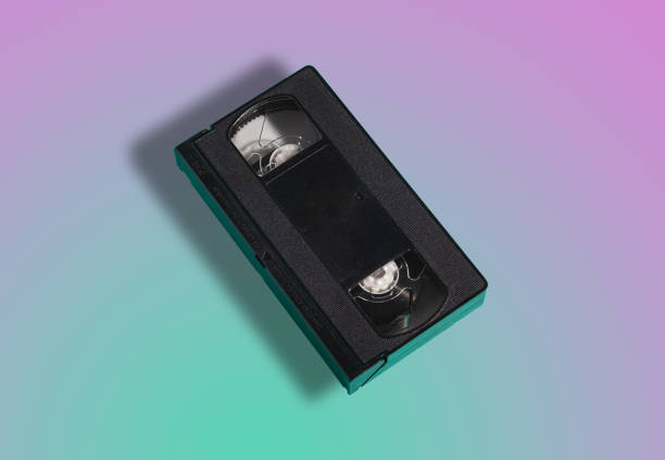 istock VHS format plastic videotape cassette, analog retro technology magnetic storage tape on gradient mint and purple background 1300212905