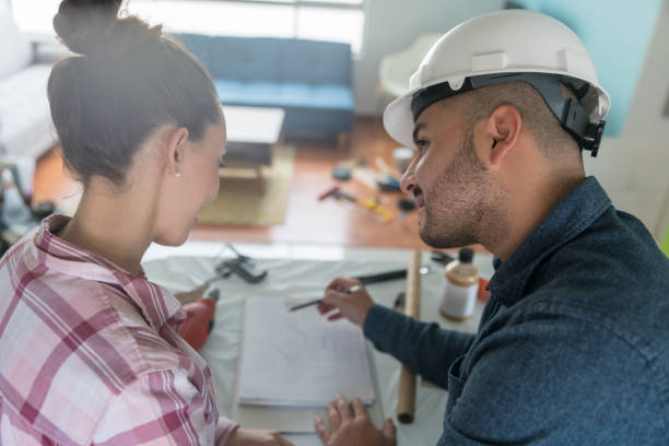 istock Contractor talking to a woman about a home addition project 1300212913