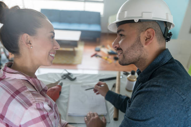 istock Architect talking to a woman at home about remodeling her kitchen 1300212921