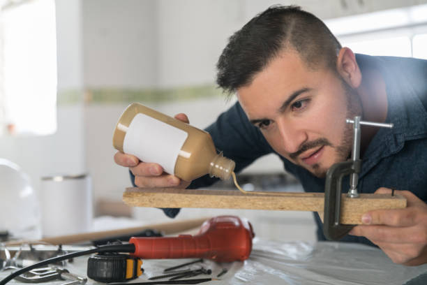 A builder works restoring a domestic kitchen