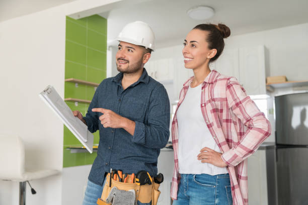 istock Contractor talking to a woman about remodeling her house 1300212959