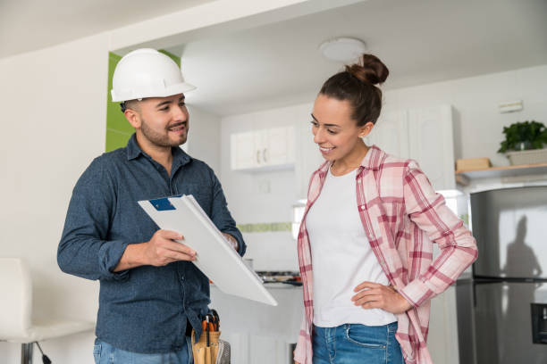 istock Architect talking to a woman about remodeling her house 1300212960