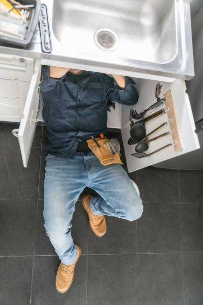 istock Plumber fixing a problem with the sink in the kitchen 1300212961