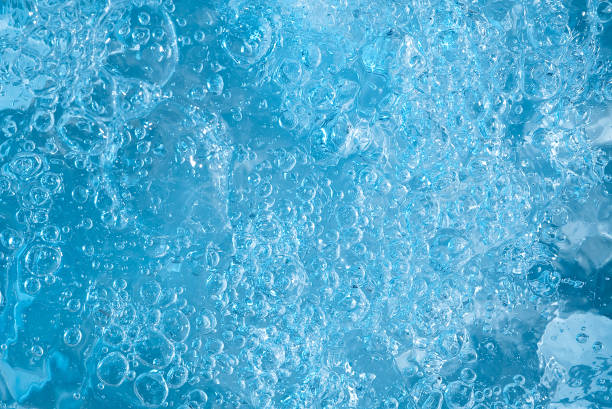 istock blue transparent clean drinking water abstract background. water surface with air bubbles background 1300213915