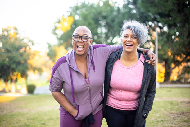 istock Two black woman walking through a grass field 1300215108