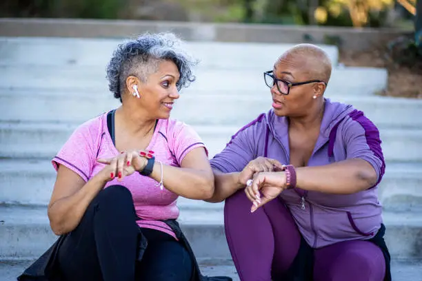 Photo of Two black woman relaxing after workout