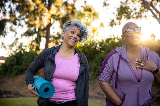 Black friends walking away with her yoga mat Senior black women working out. lgbtqcollection stock pictures, royalty-free photos & images