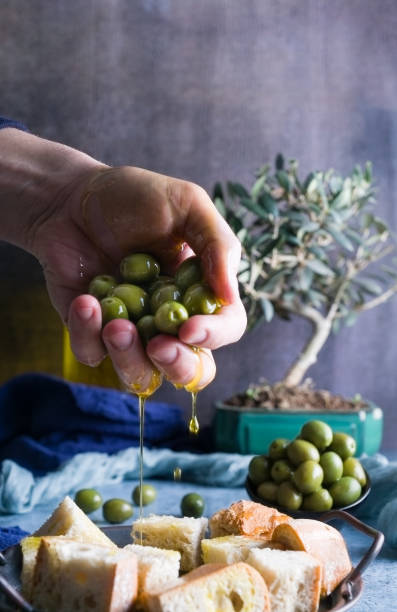 istock Oil, hands and olives 1300215798