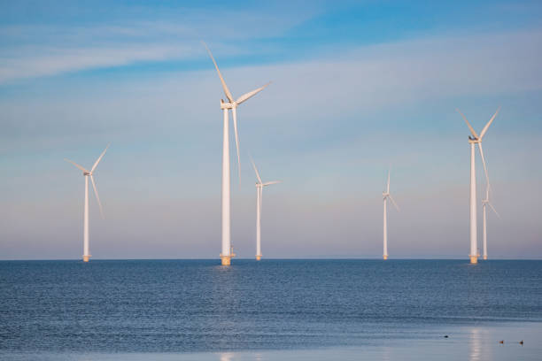 istock offshore windmill park with stormy clouds and a blue sky, windmill park in the ocean. Netherlands 1300216933