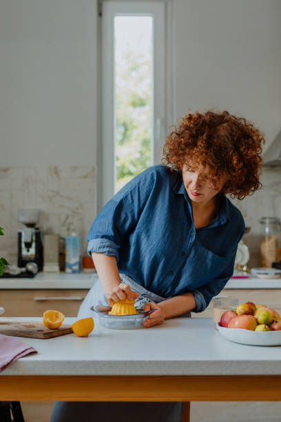 istock Happy Caucasian Woman  Making a Delicious Mint Lemonade 1300216975