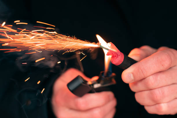 istock Firecracker Burning in Hand with Sparks and Smoke 1300219643