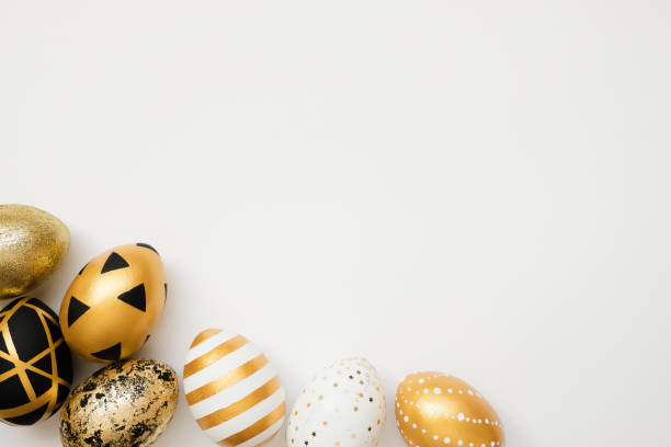 istock Frame of Easter golden decorated eggs isolated on white background. Minimal easter concept. Happy Easter card with copy space for text. Top view, flatlay 1300222064